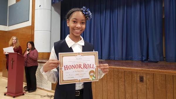 St. Clare student with certificate